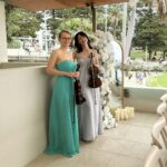 Professional female violin duo in elegant gowns performing live music for an outdoor event in Sydney.