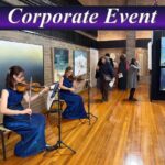 Professional female violinists performing live music for a corporate event cocktail hour in Sydney.