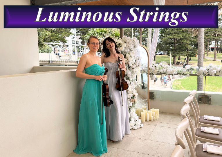 Two female musicians from Luminous Strings performing with a violin and cello at a bright outdoor event venue.