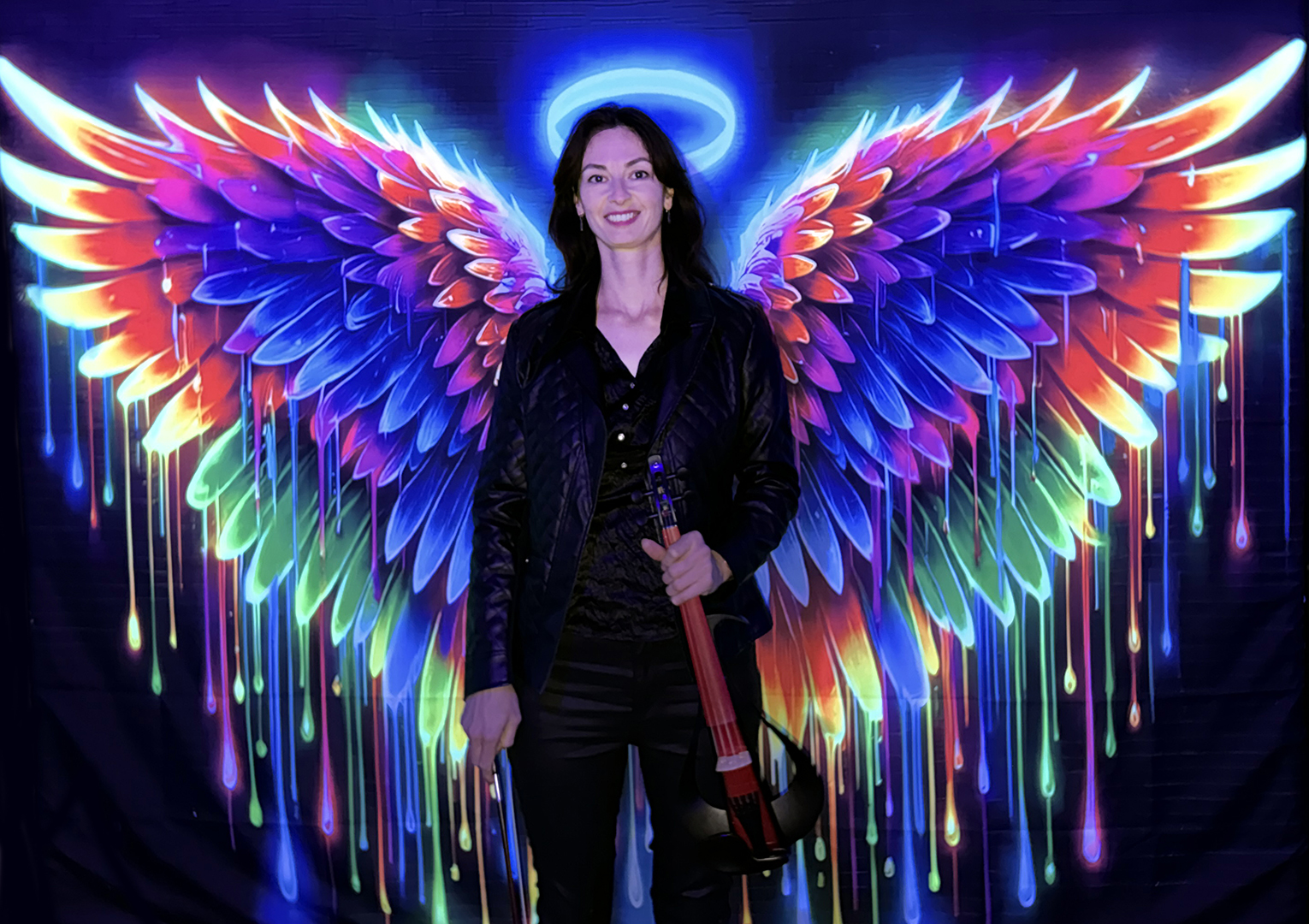 Professional solo electric violinist performing with neon angel wings backdrop for corporate events and weddings.