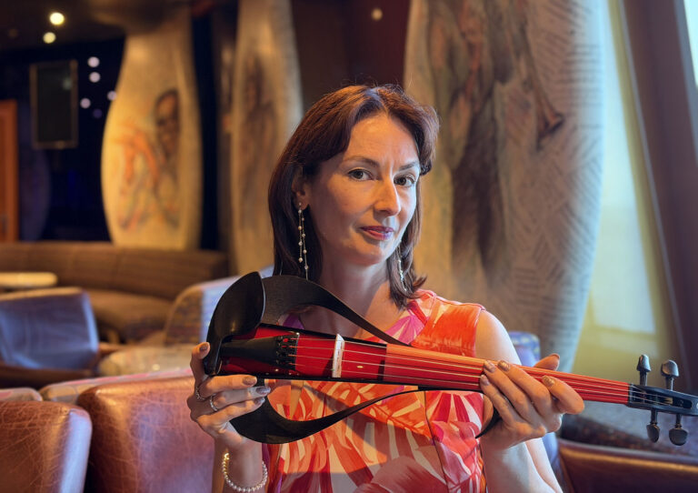 Professional solo electric violinist performing live wedding music for a guest reception.