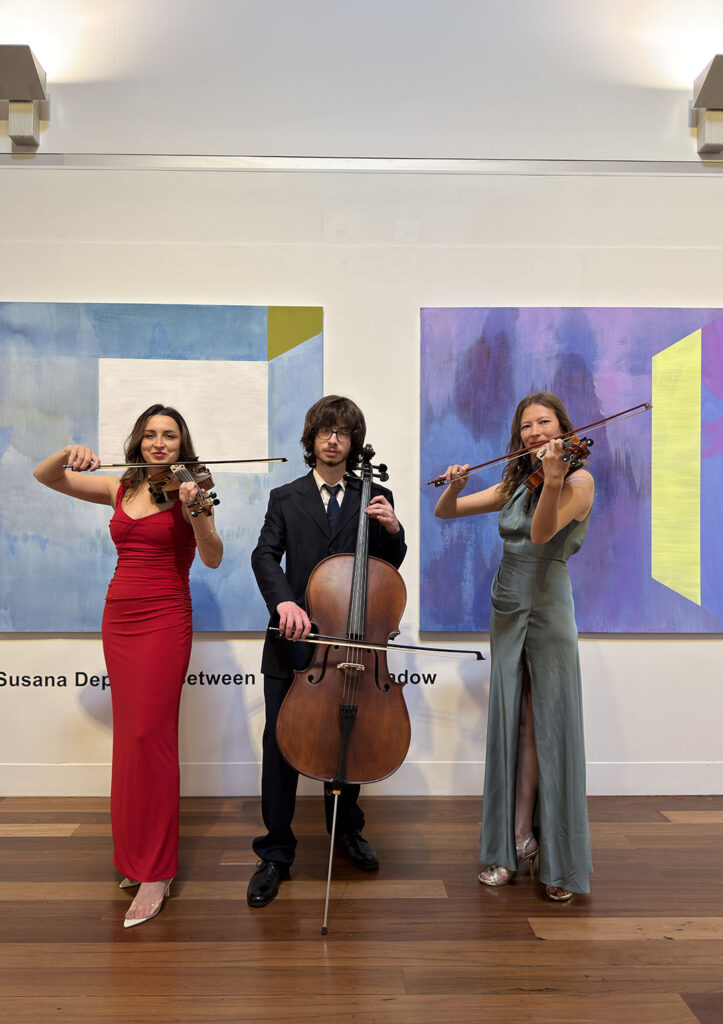 Professional live string trio performing with two violinists and a cellist at a Sydney event.