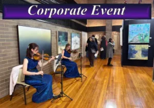 Professional female violinists performing live music for a corporate event cocktail hour in Sydney.