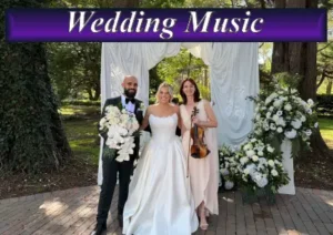 Live wedding music performance with a solo violinist alongside a bride and groom at an outdoor reception.
