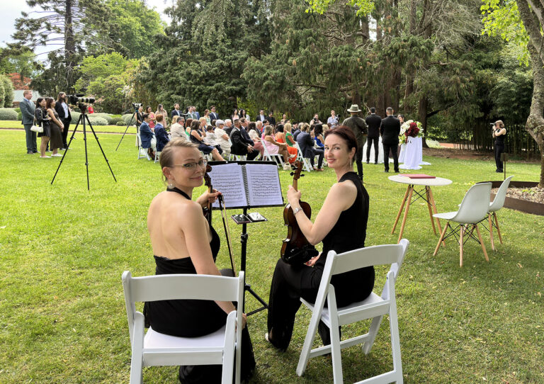 Live wedding music duo performing outdoor ceremony strings for Luminous Strings