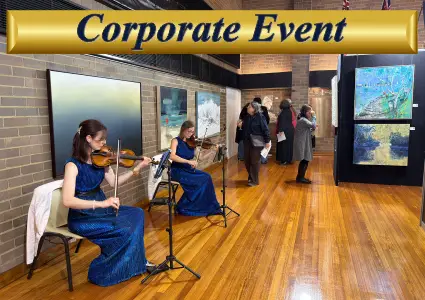 Professional female violinists performing live music for a corporate event cocktail hour in Sydney.