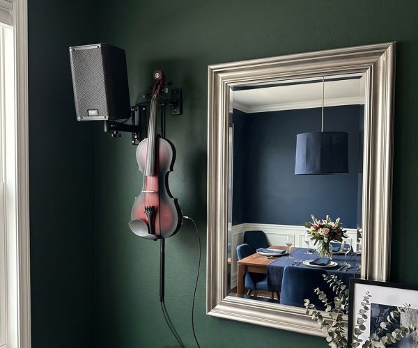 Solo electric violinist for events in Sydney, featuring a red and black Yamaha electric violin on a wall-mounted stand.